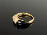 an image of a gold ring with diamonds on a black surface