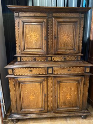 an antique wooden cabinet with four doors and four drawers