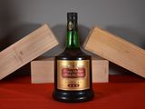 a bottle of alcohol sitting on a table with wooden blocks