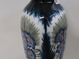 a blue and white vase sitting on a white surface