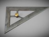 a close up of a metal triangle on a white surface
