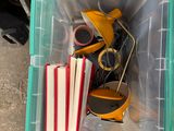 a plastic container with books and a pair of shoes in it
