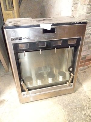 a silver oven sitting in the middle of a room