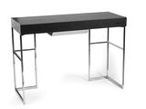 the desk has a black top and chrome legs