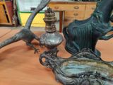 a bronze statue of a woman and a bird on a table