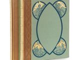 the three books are lined up in a row on a white surface