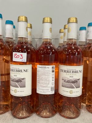 several bottles of wine are lined up on a counter
