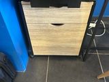 a small cabinet with a drawer on it in the corner of a room