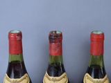 three bottles of wine that are sitting on a table