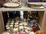 many plates and vases on a shelf in a store