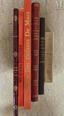 several books are stacked on top of each other on a table