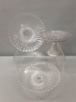 two clear glass dishes sitting on top of a table next to each other