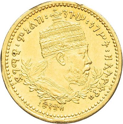 a close up of a gold coin with an image of a man in a turban