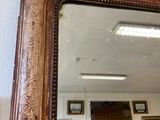 a large mirror hanging on the wall in a room
