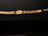 a gold bracelet with a square clasp and a gold clasp