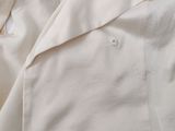 a close up of a white shirt with holes on it