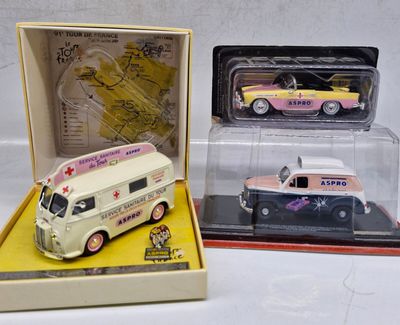 three toy cars in a display case on a table