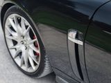 a close up of a car door handle on the side of the road