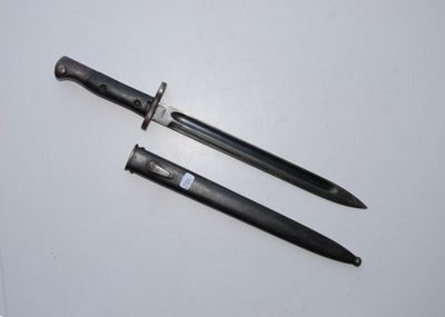 two knives are laying next to each other on a white surface