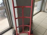 a red hand truck that is sitting on the floor