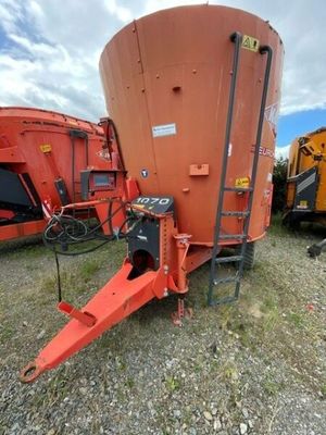 a close up of a tractor and a grainer in a field