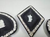 three black and white plates with white designs on them