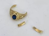 a close up of a gold ring with a blue stone on it