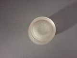 a white cup with a lid sitting on a table