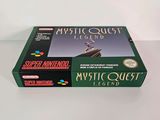 the box for the game mystic quest legend is sitting on a table