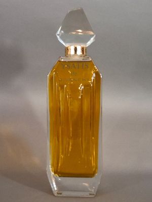 a small bottle of perfume sitting on a white surface