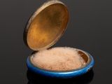 a small bowl of sugar sitting on a black surface