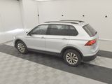 the back end of a white volkswagen suv parked in a garage