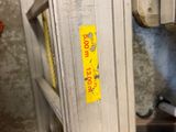 a close up of a piece of metal with a yellow sticker on it