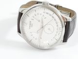 a close up of a watch on a white surface