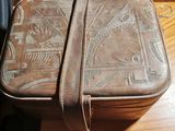 a brown suitcase sitting on a wooden table