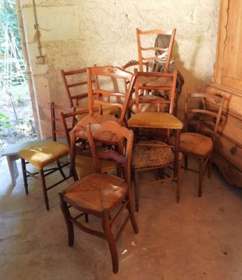 many chairs and a dresser in a room