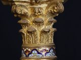 an image of a gold and green vase with a marble top