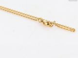 a gold chain with a heart charm on it