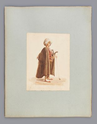une vieille photo d'un homme en manteau et chapeau, muni d'une canne