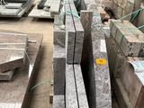 a large pile of granite blocks in a warehouse