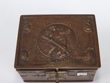 an antique brass box with an image of a man holding a sword