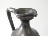 a silver vase with a handle on a white background