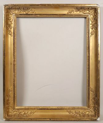 a gold picture frame with a white wall behind it