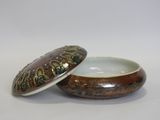 a small bowl with a lid sitting on a table