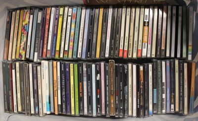 une boîte remplie de divers CD posée par terre