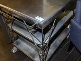 a metal table with a metal shelf on it