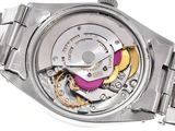 a close up of a watch with a metal band