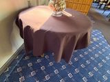 a small table with a vase of flowers on top of it