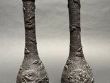 two vases that are sitting side by side on a table