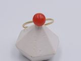 an image of a ring with a red stone on top of it
